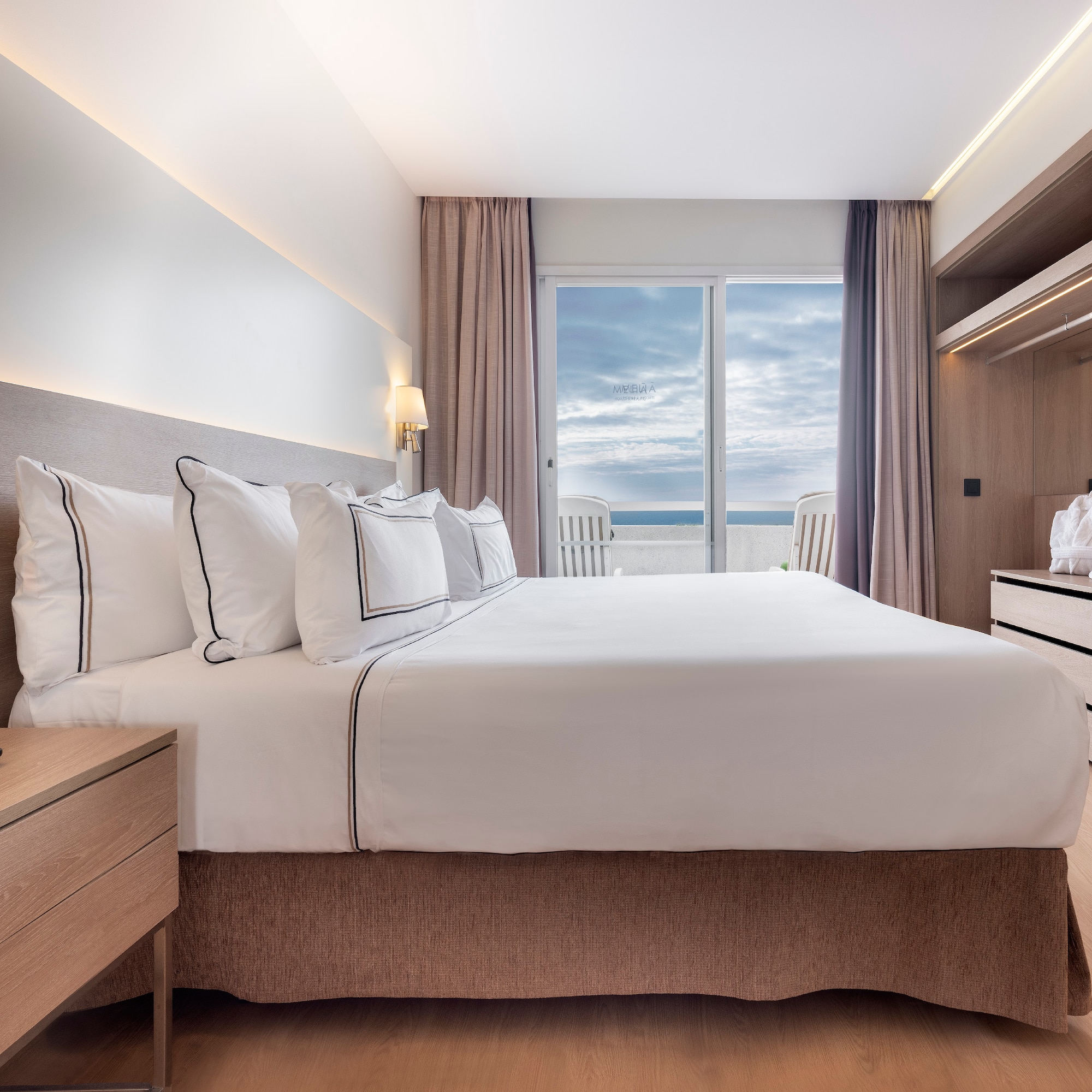 a bedroom with a large bed and a dresser