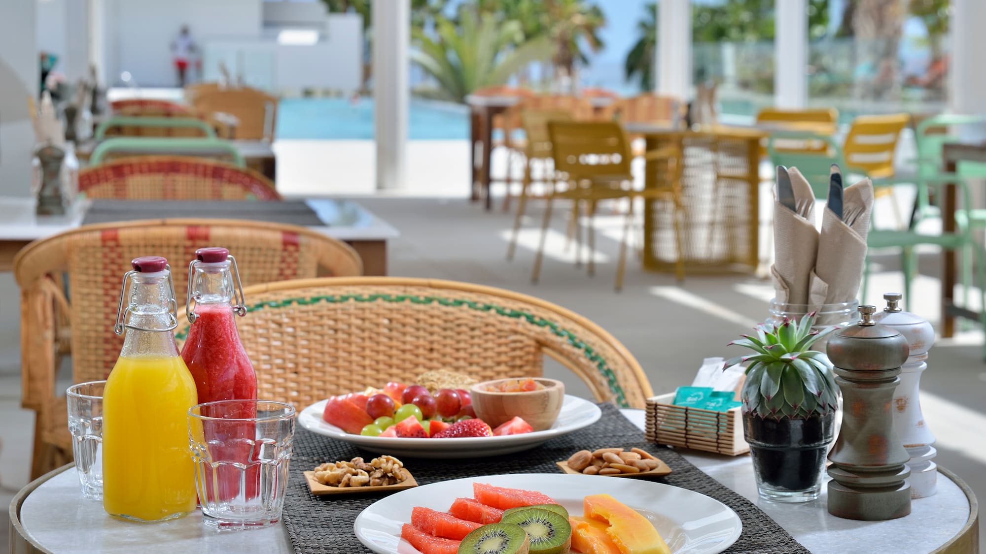 a table with plates of fruit and drinks on it