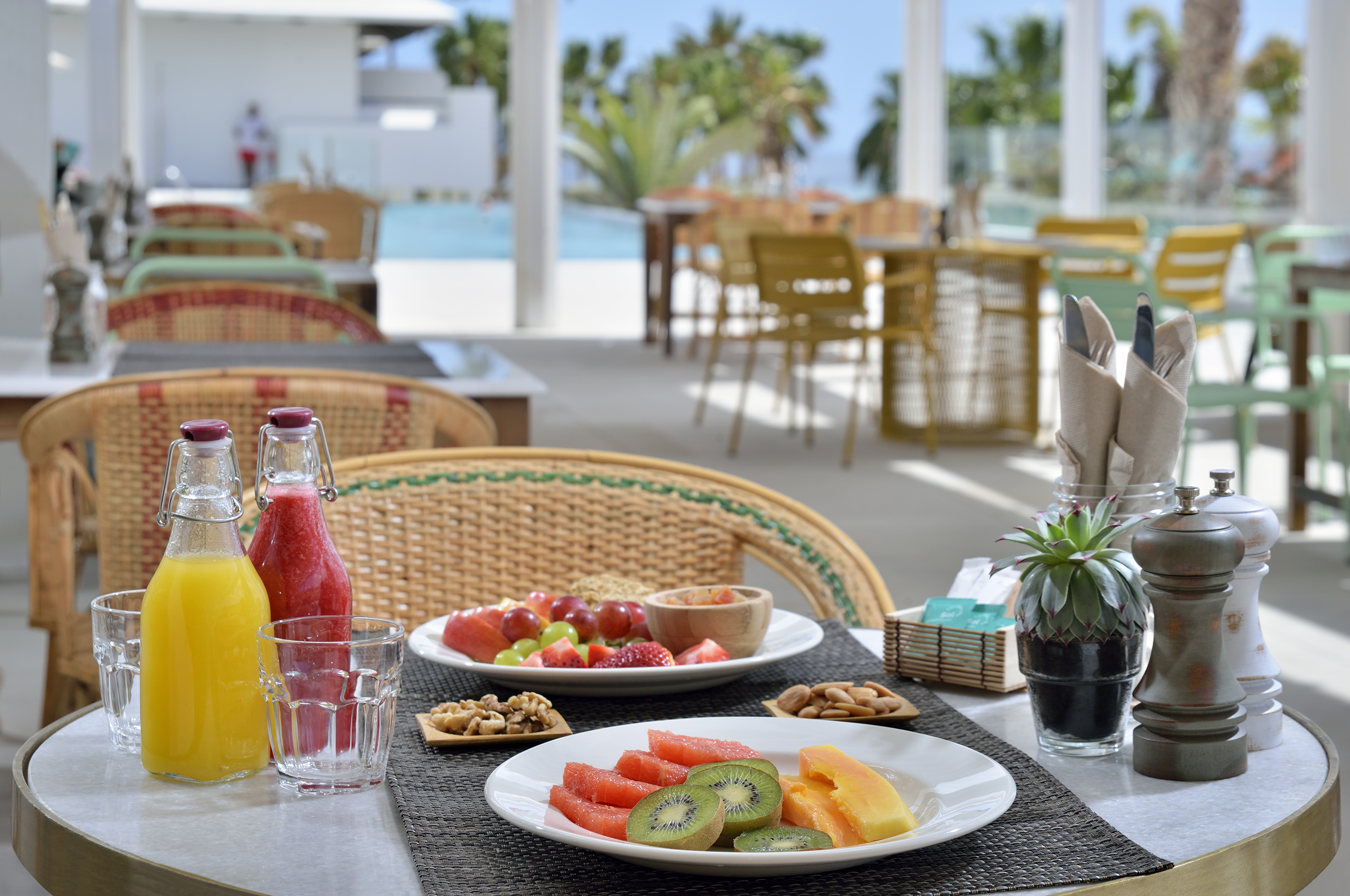 a table with plates of fruit and drinks on it