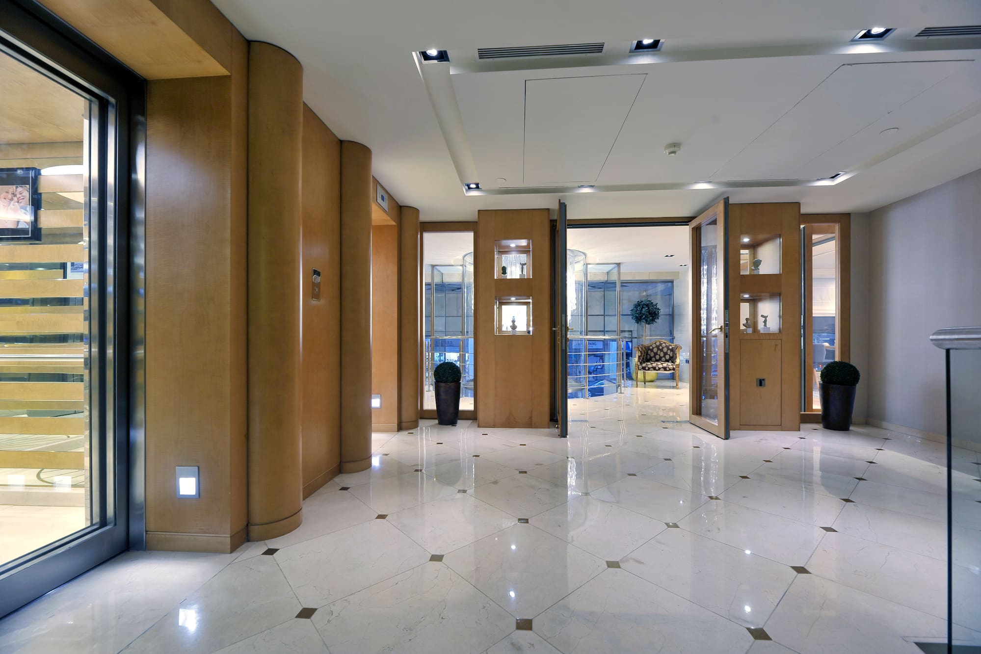 a room with glass doors and a plant