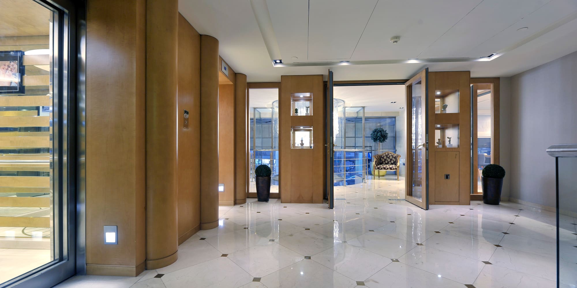 a room with glass doors and a plant