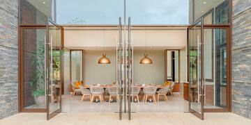 a glass doors with a table and chairs