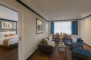 a room with a couch and chairs
