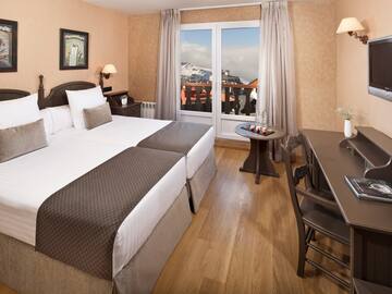 a room with two beds and a table