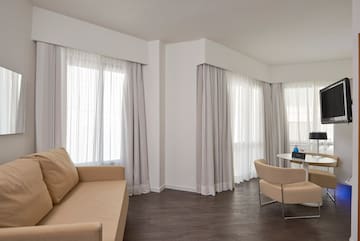 a living room with a couch and chairs