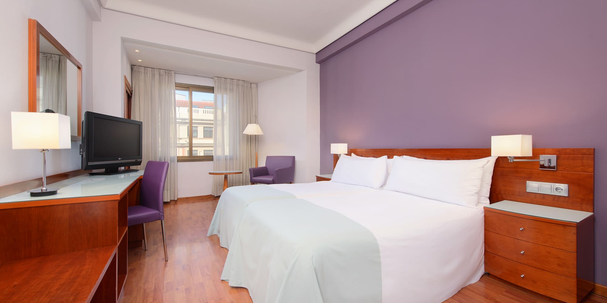 a room with a bed and a desk