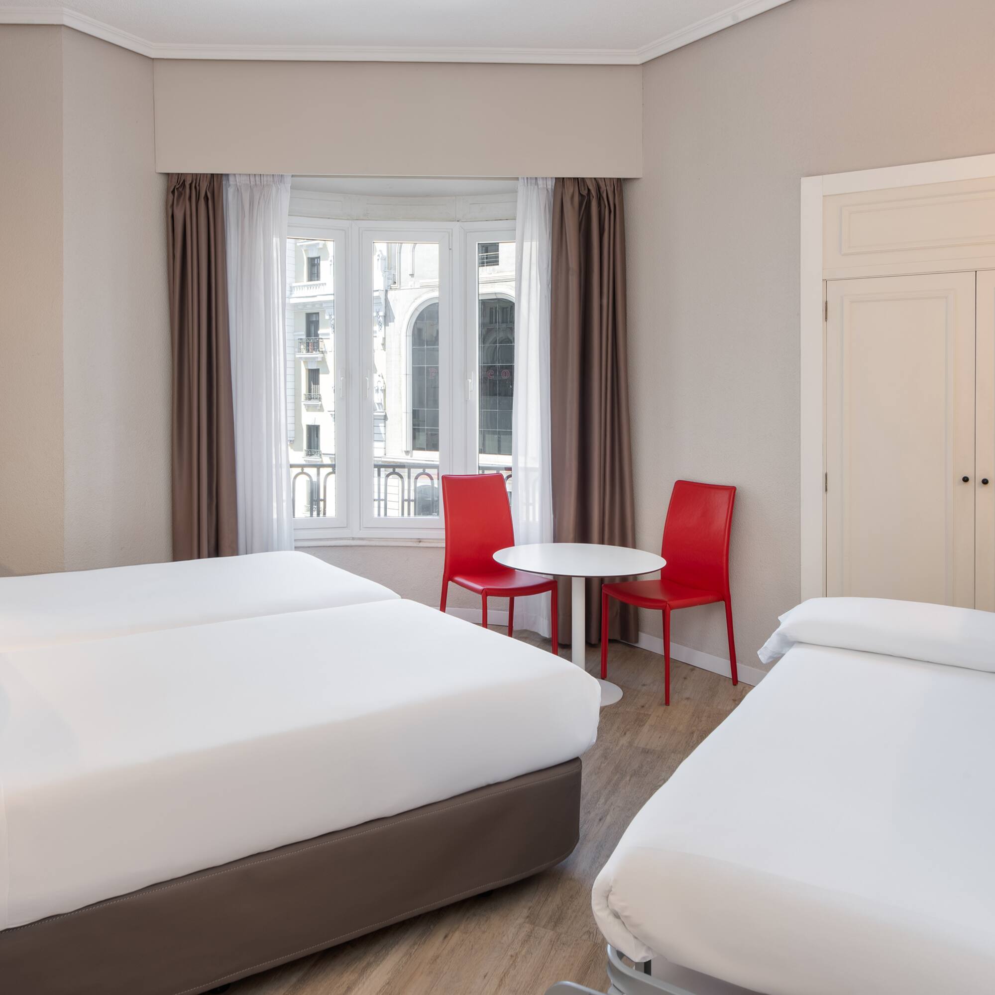 a room with two beds and a table