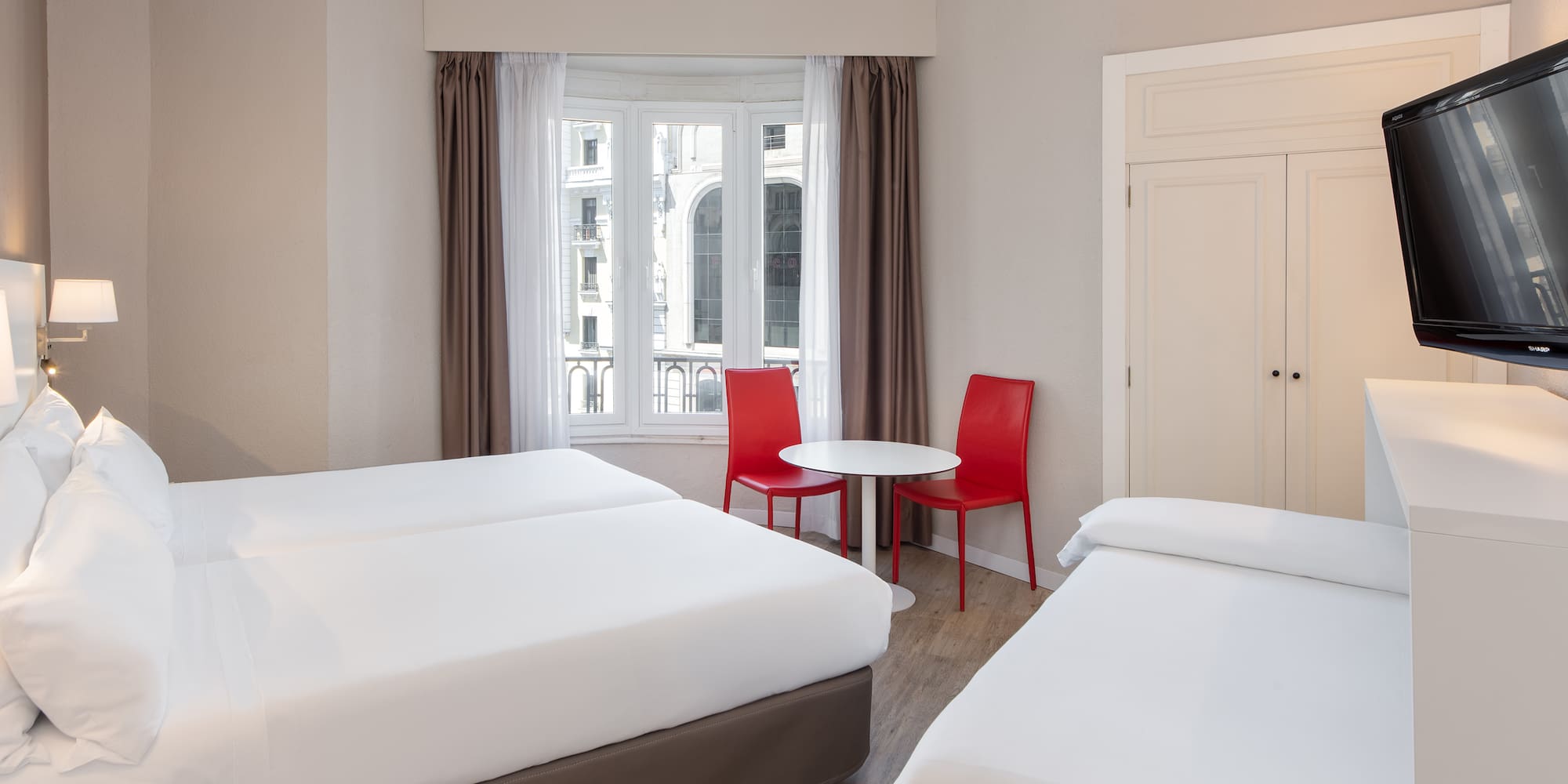 a room with two beds and a table