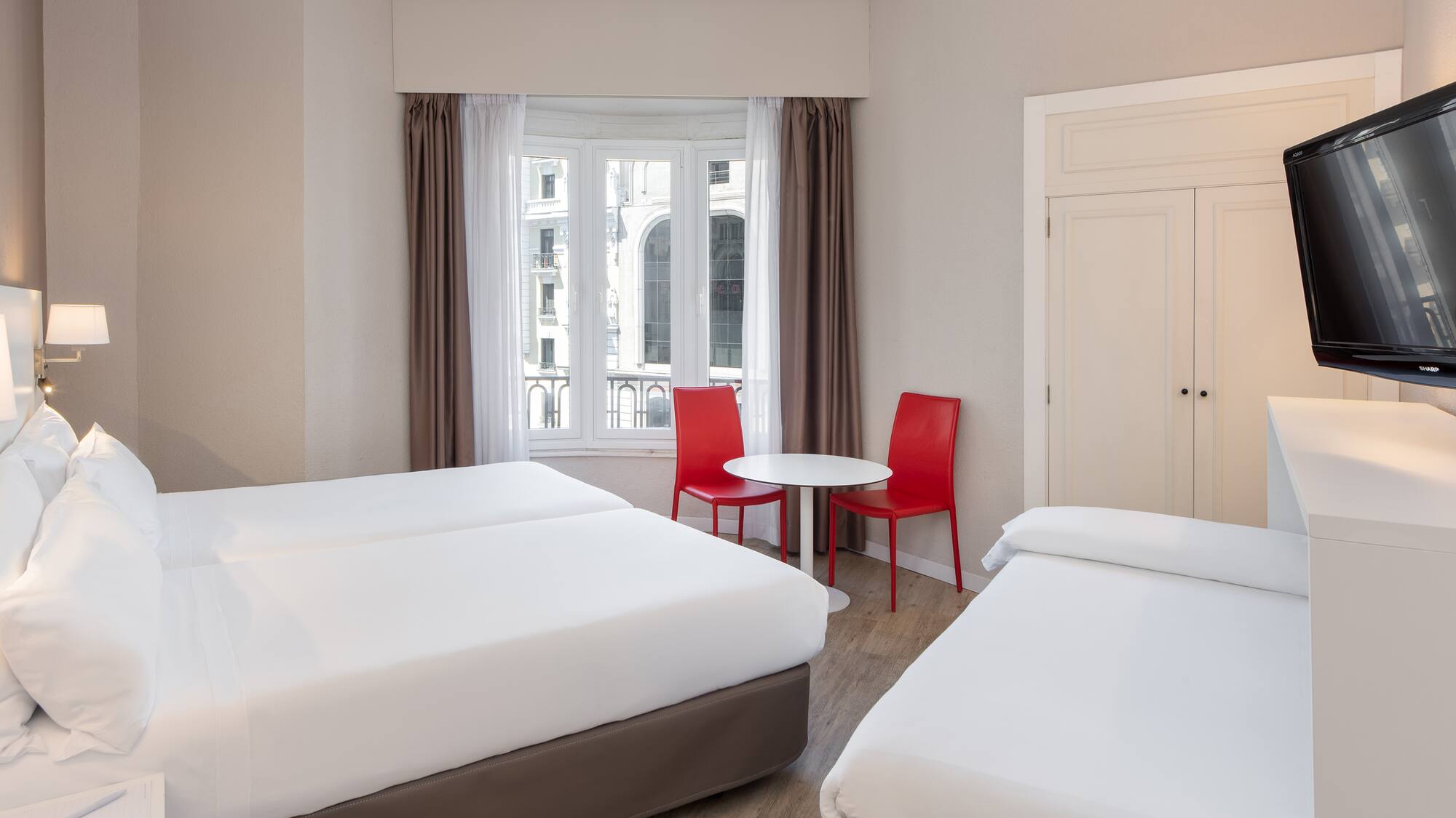 a room with two beds and a table