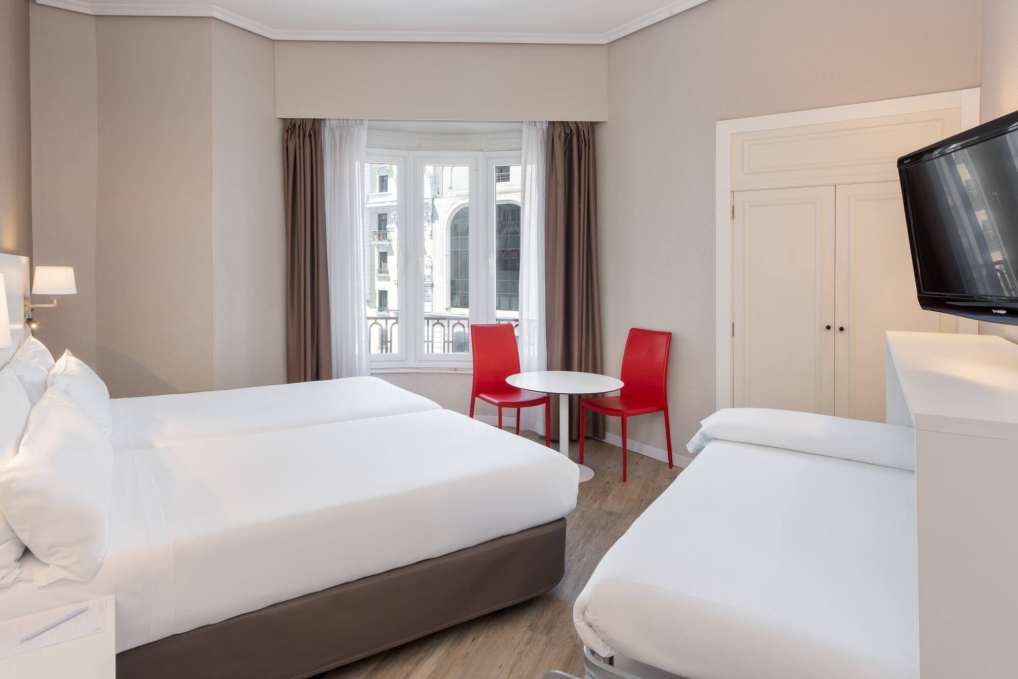 a room with two beds and a table