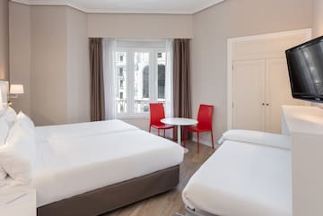 a room with two beds and a table