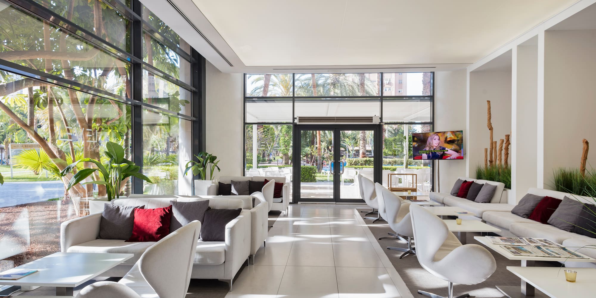 a room with white furniture and glass doors