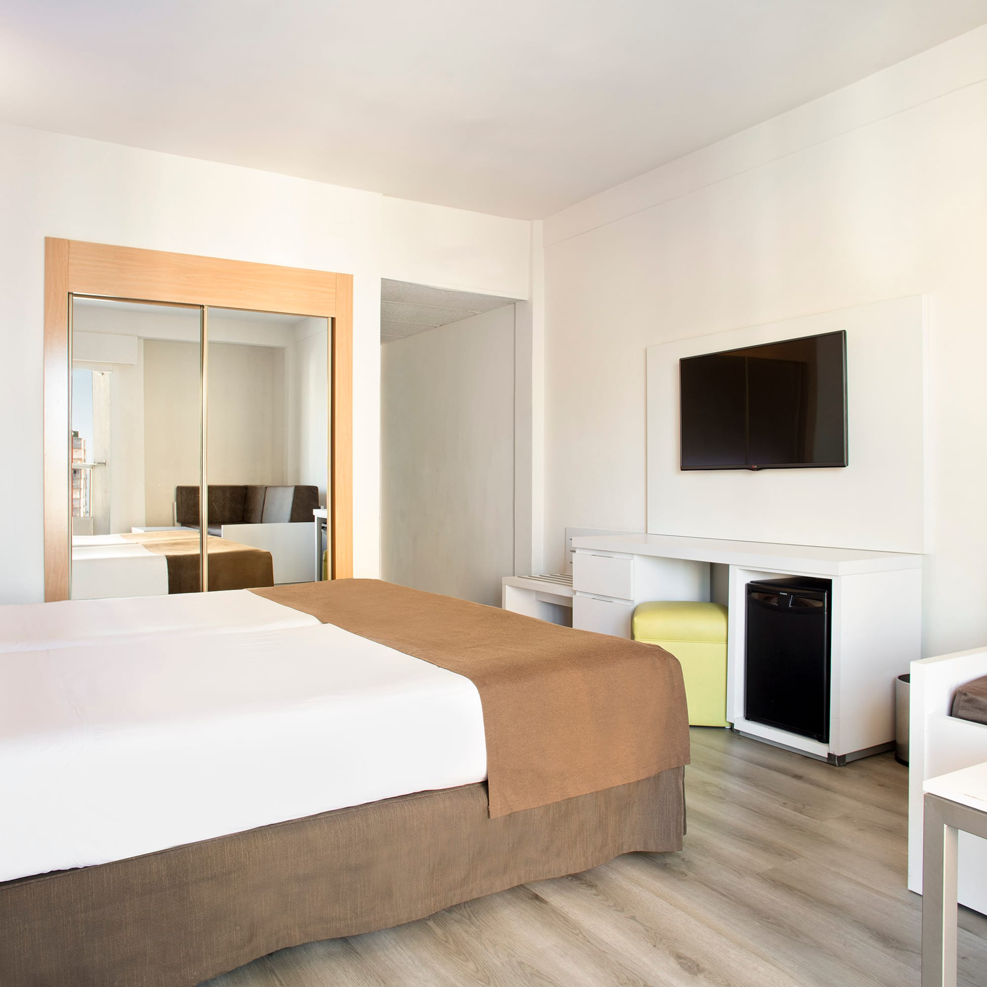 a room with a bed and a television