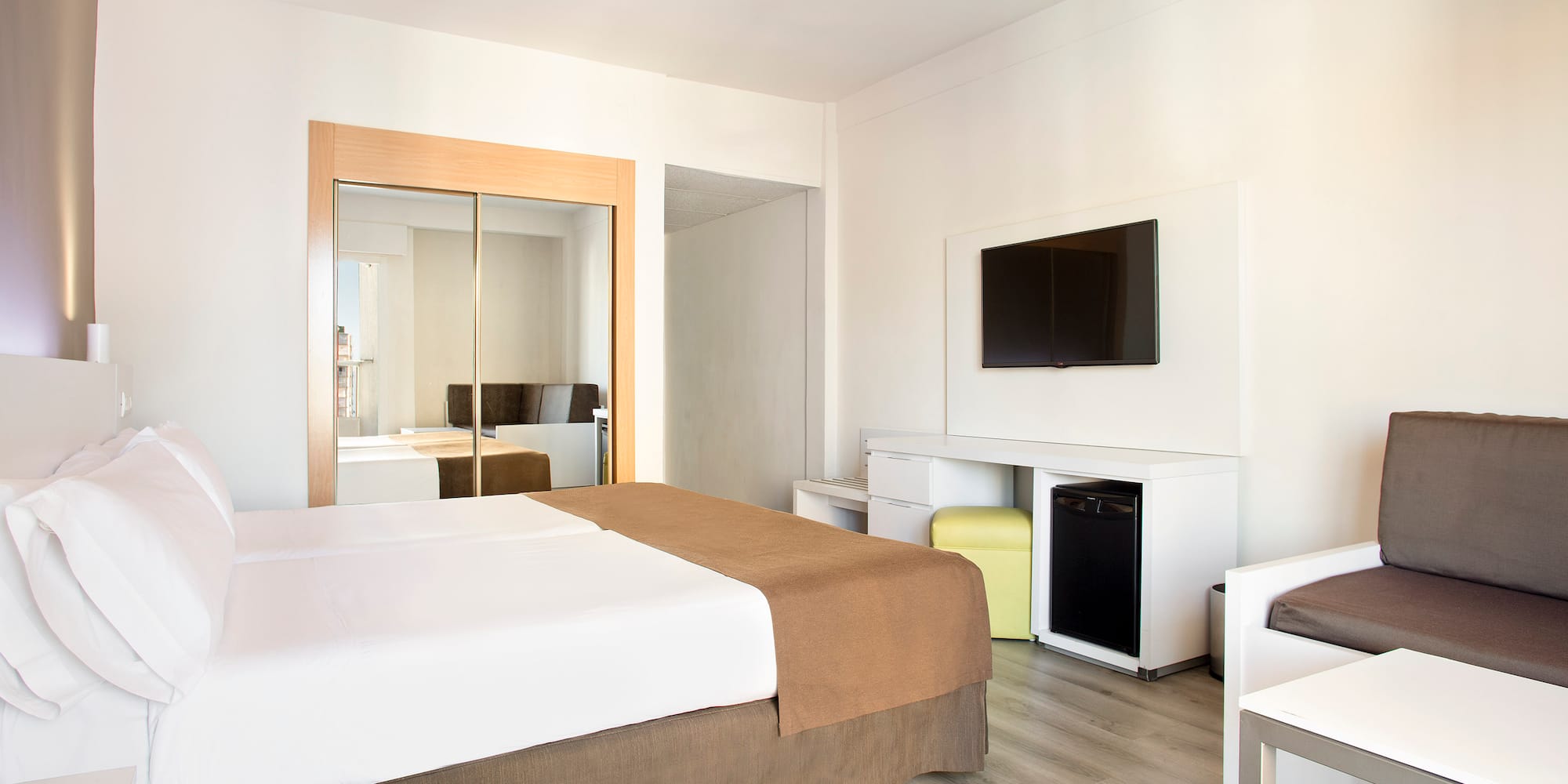 a room with a bed and a television