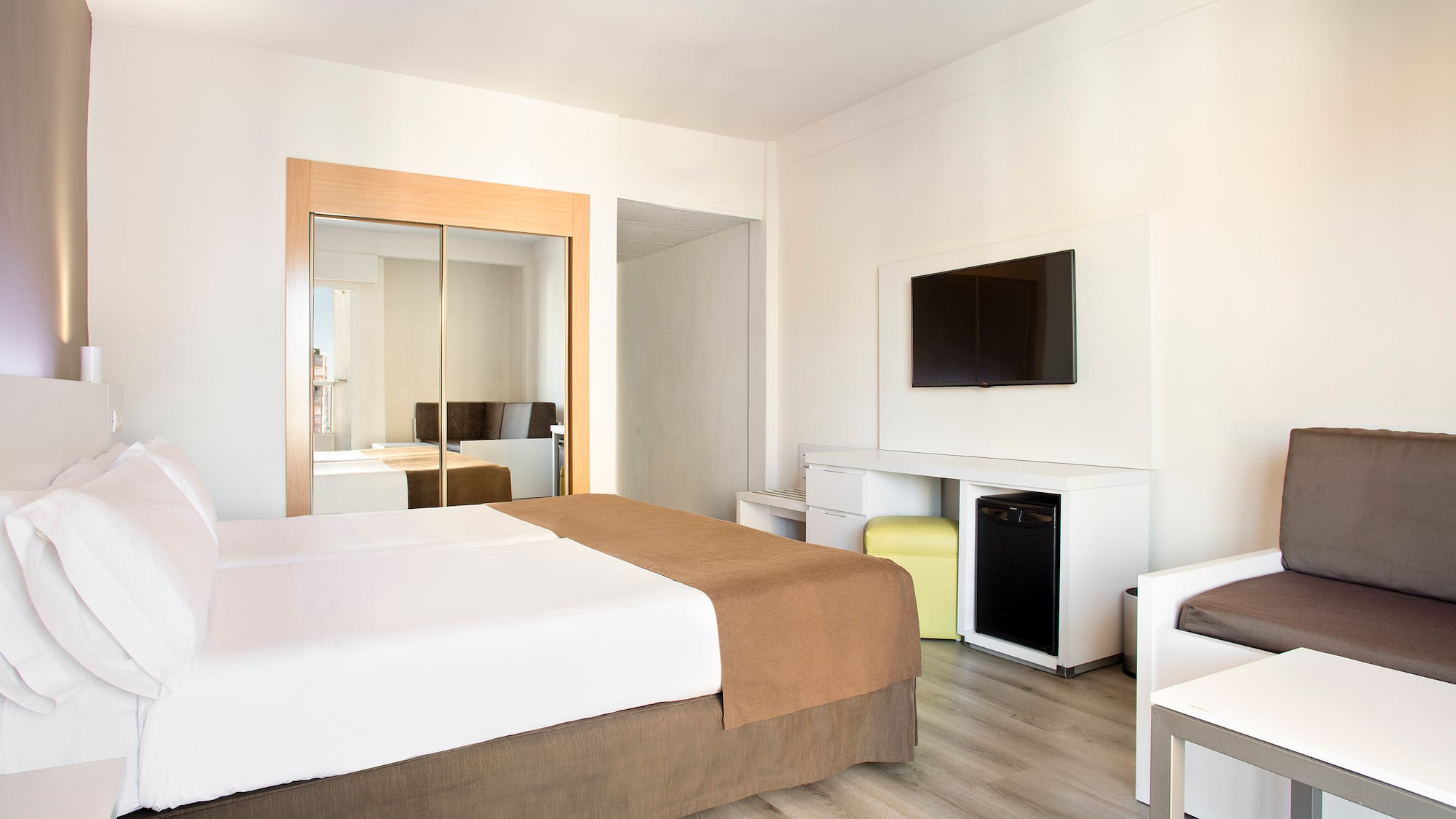 a room with a bed and a television