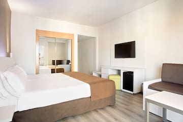 a room with a bed and a television