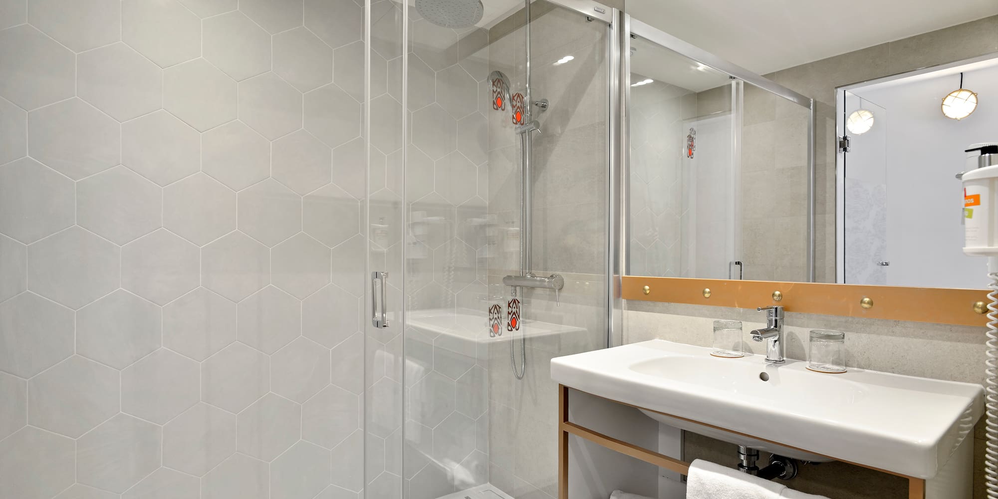 a bathroom with a glass shower door