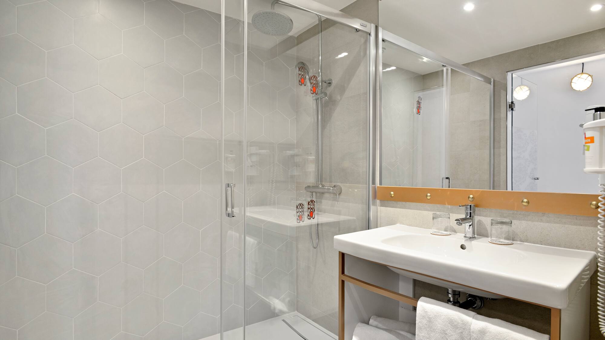 a bathroom with a glass shower door