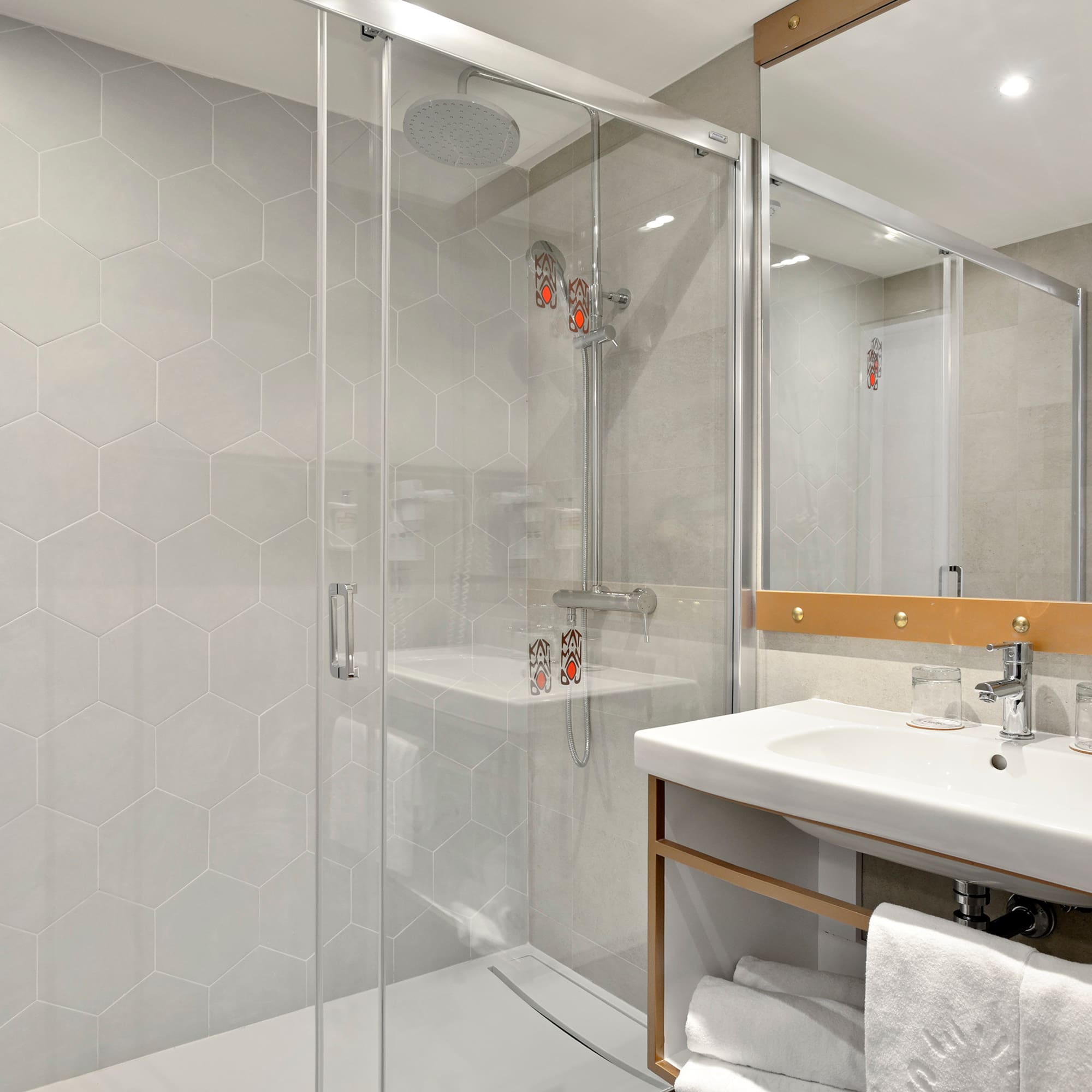 a bathroom with a glass shower door