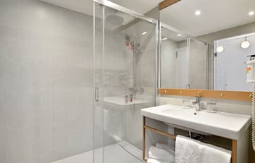 a bathroom with a glass shower door