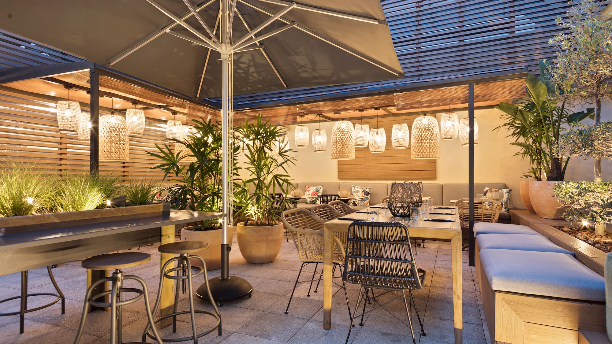 a patio with tables and chairs and umbrellas