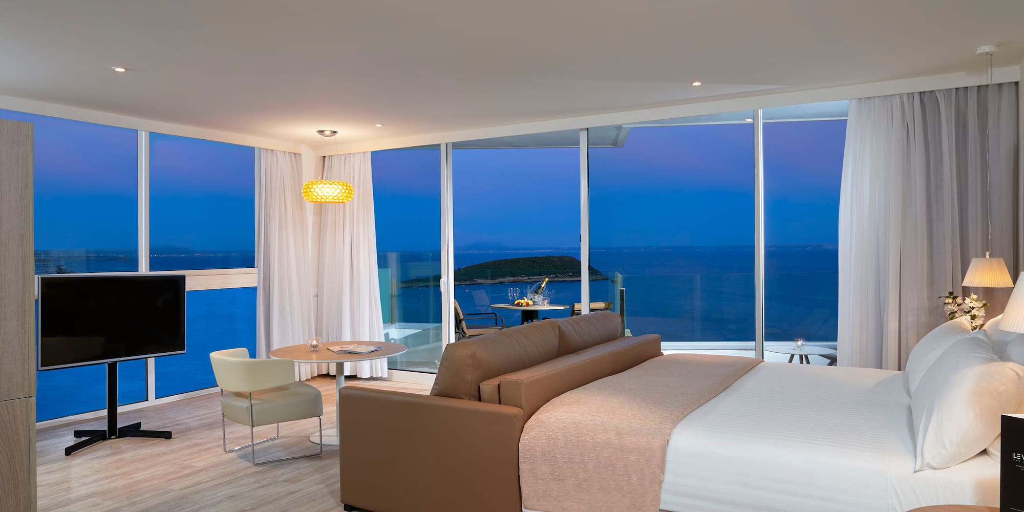 a room with a large window overlooking the ocean