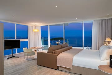 a room with a large window overlooking the ocean