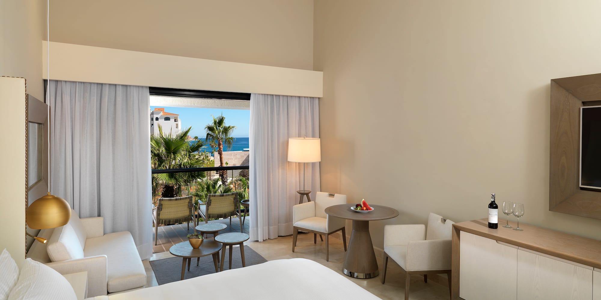 a room with a bed and chairs and a table