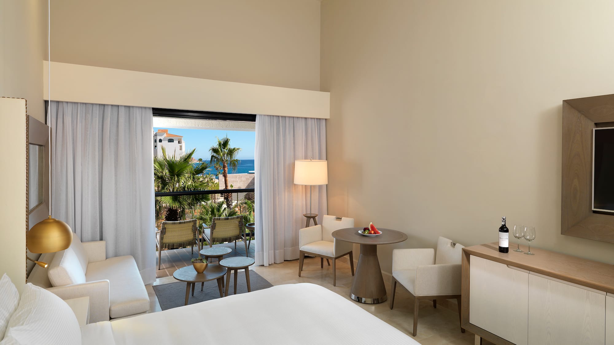 a room with a bed and chairs and a table