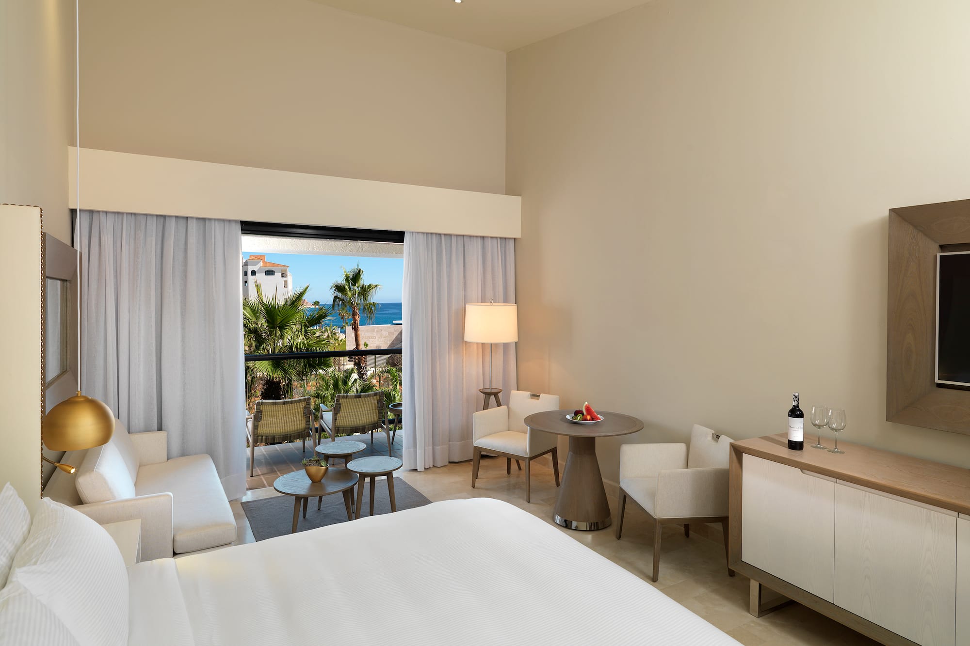 a room with a bed and chairs and a table