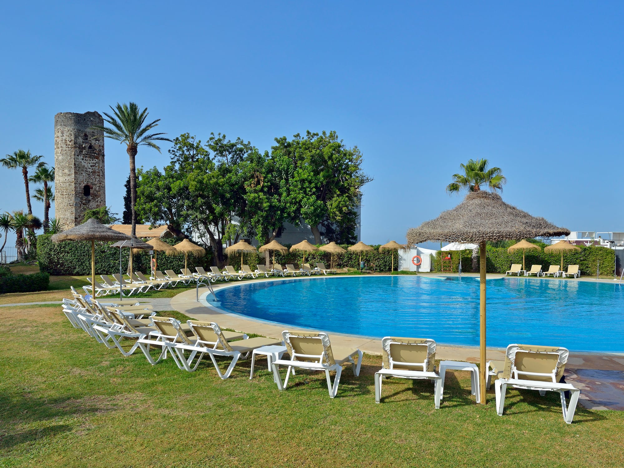 a pool with umbrellas and chairs