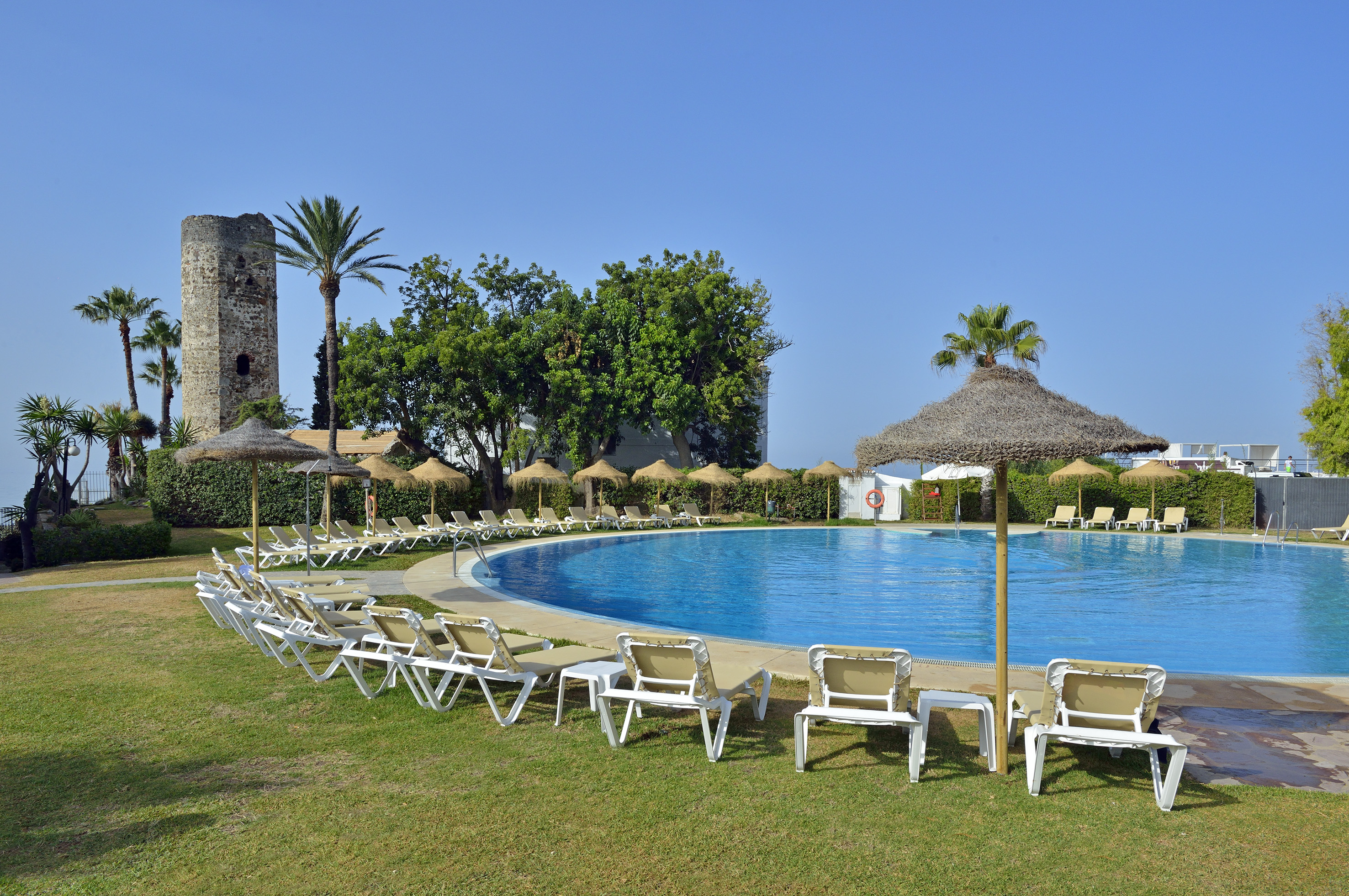a pool with umbrellas and chairs