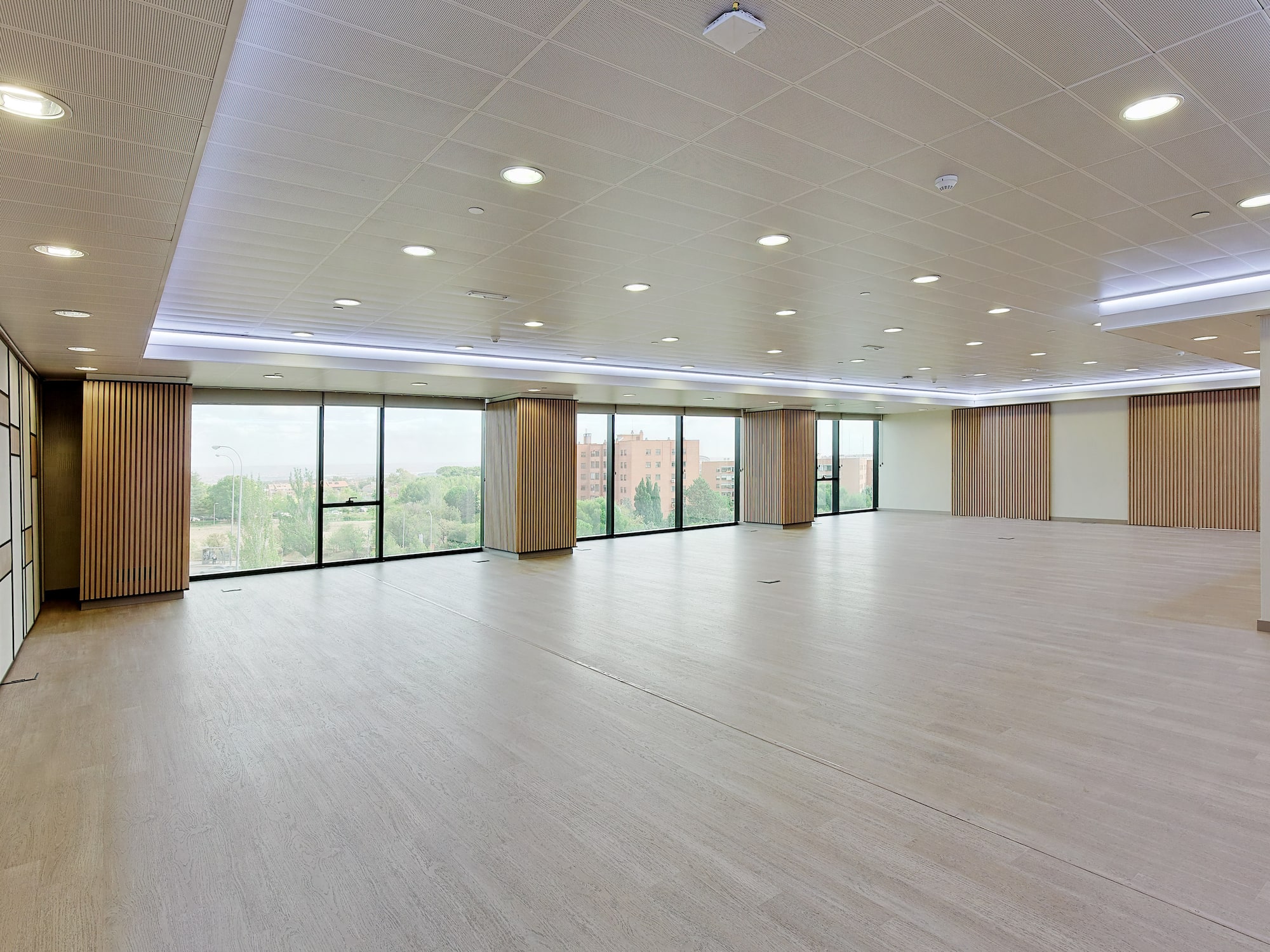 a large room with windows and a wood floor