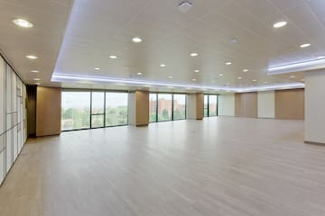 a large room with windows and a wood floor