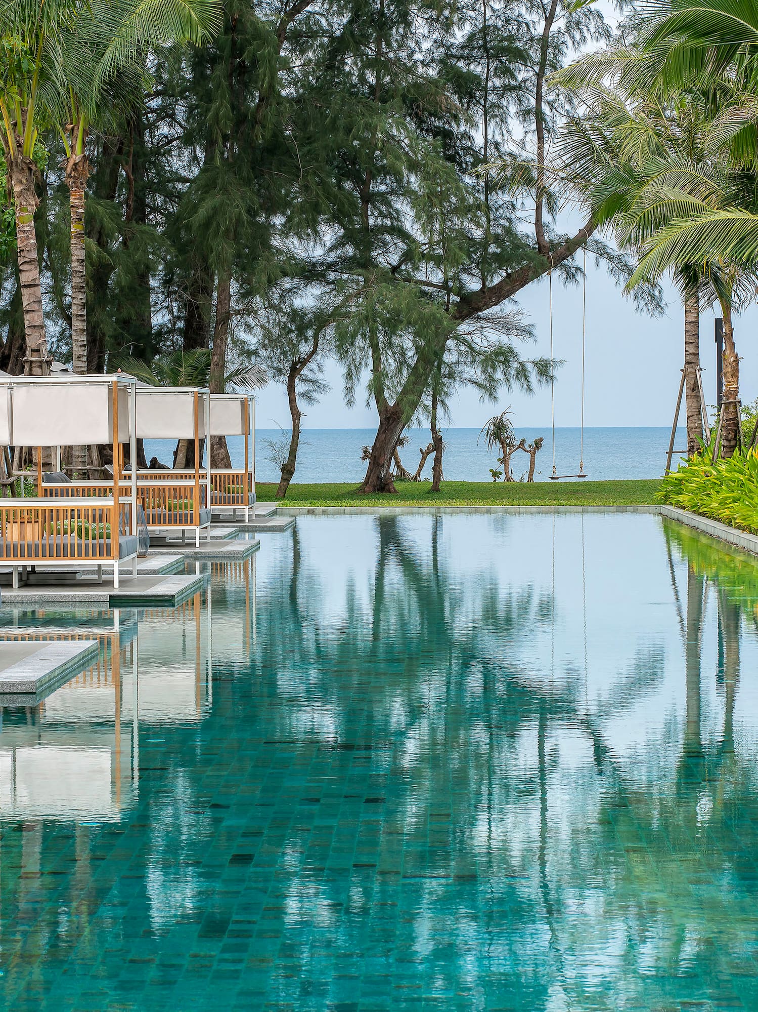 a pool with chairs and trees