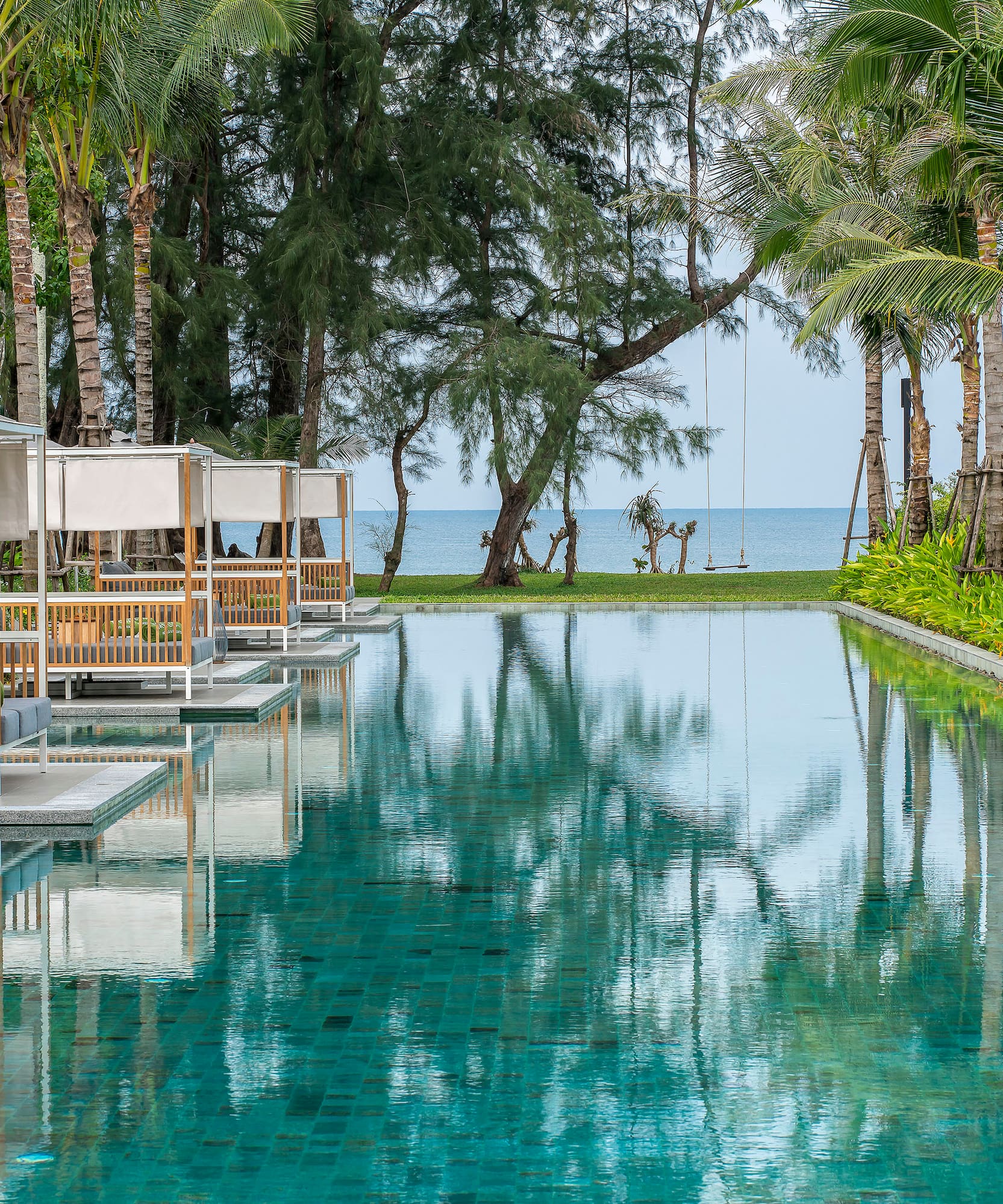 a pool with chairs and trees