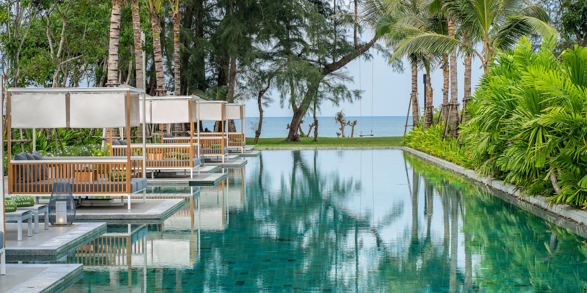 a pool with chairs and trees
