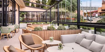 a patio with a couch and chairs