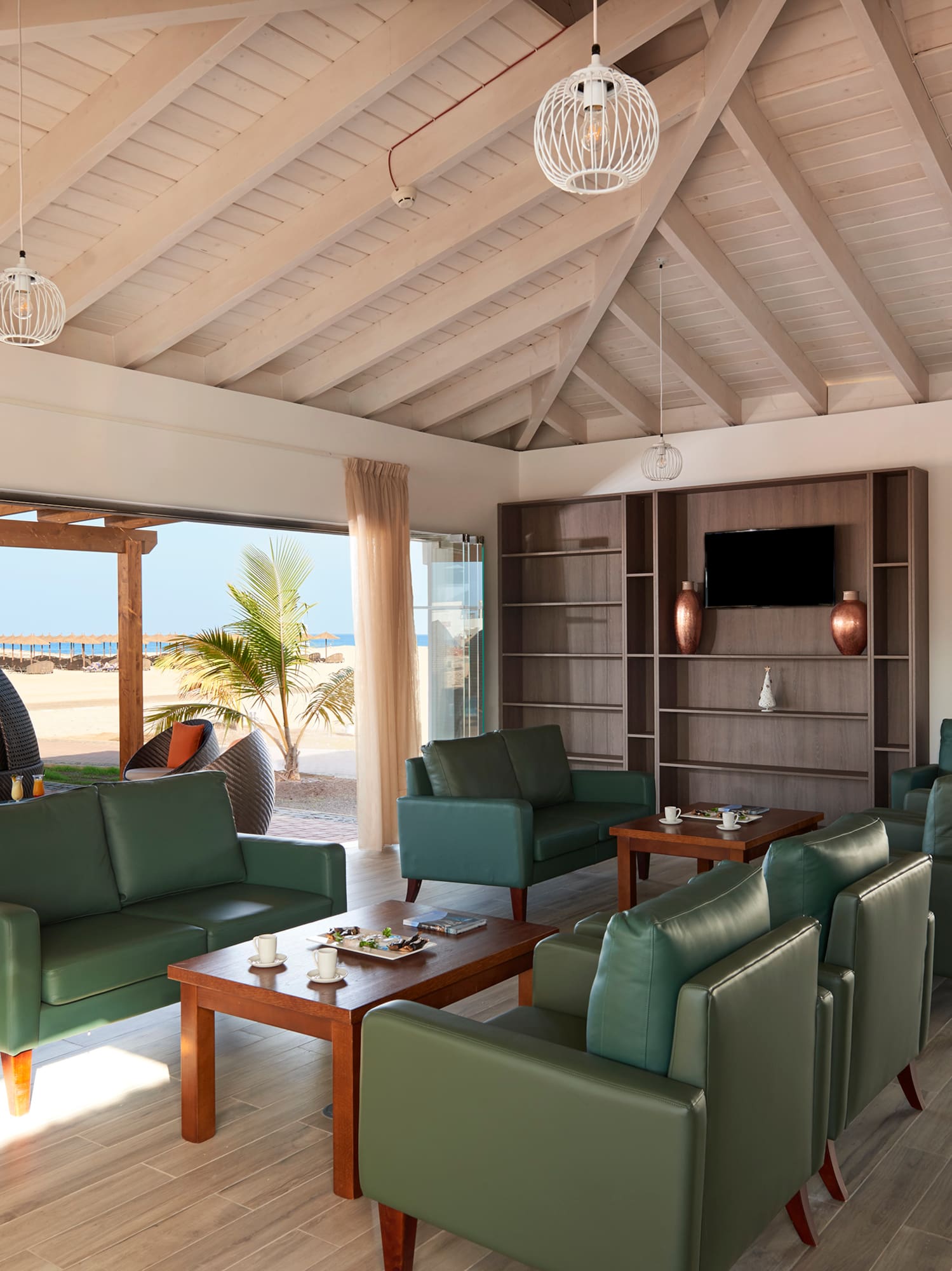 a room with green couches and a table