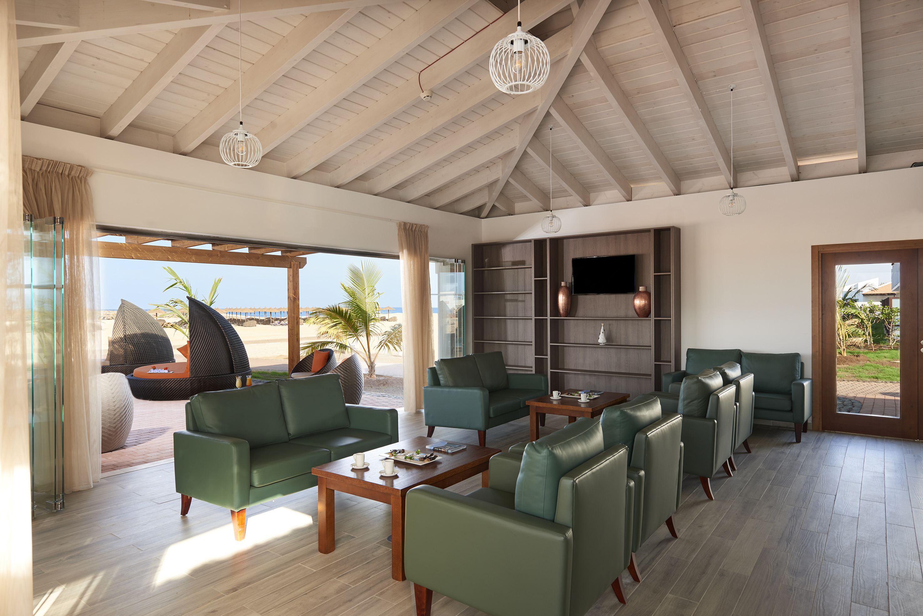 a room with green couches and a table