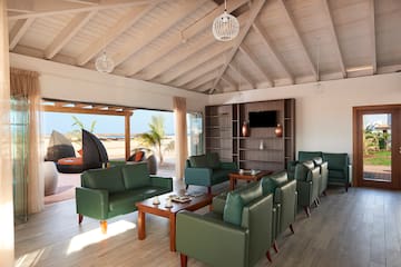 a room with green couches and a table