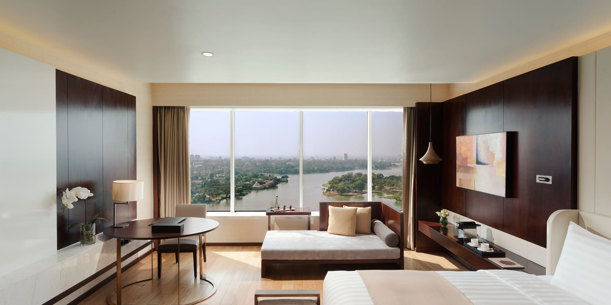 a room with a bed and a table and a window