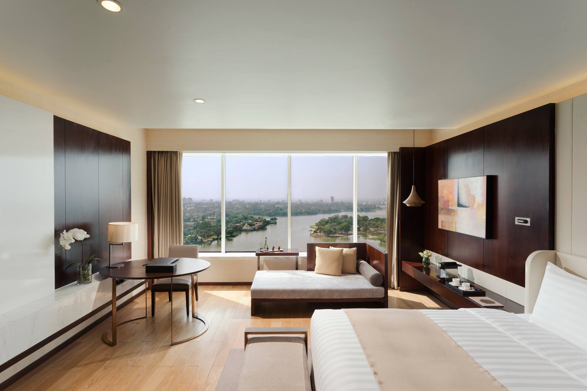 a room with a bed and a table and a window