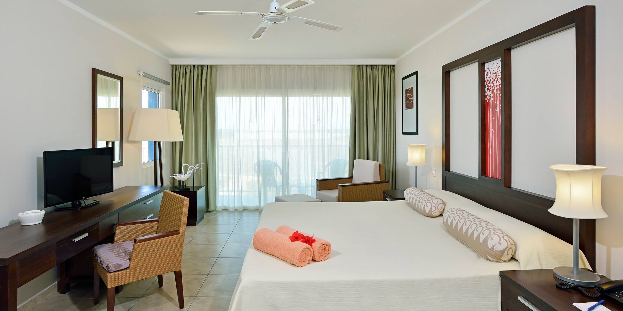 a room with a bed and a fan