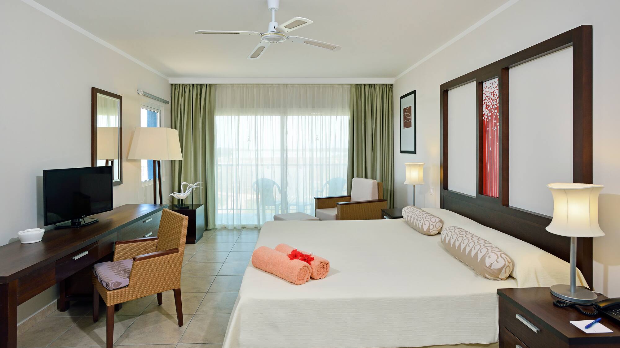 a room with a bed and a fan