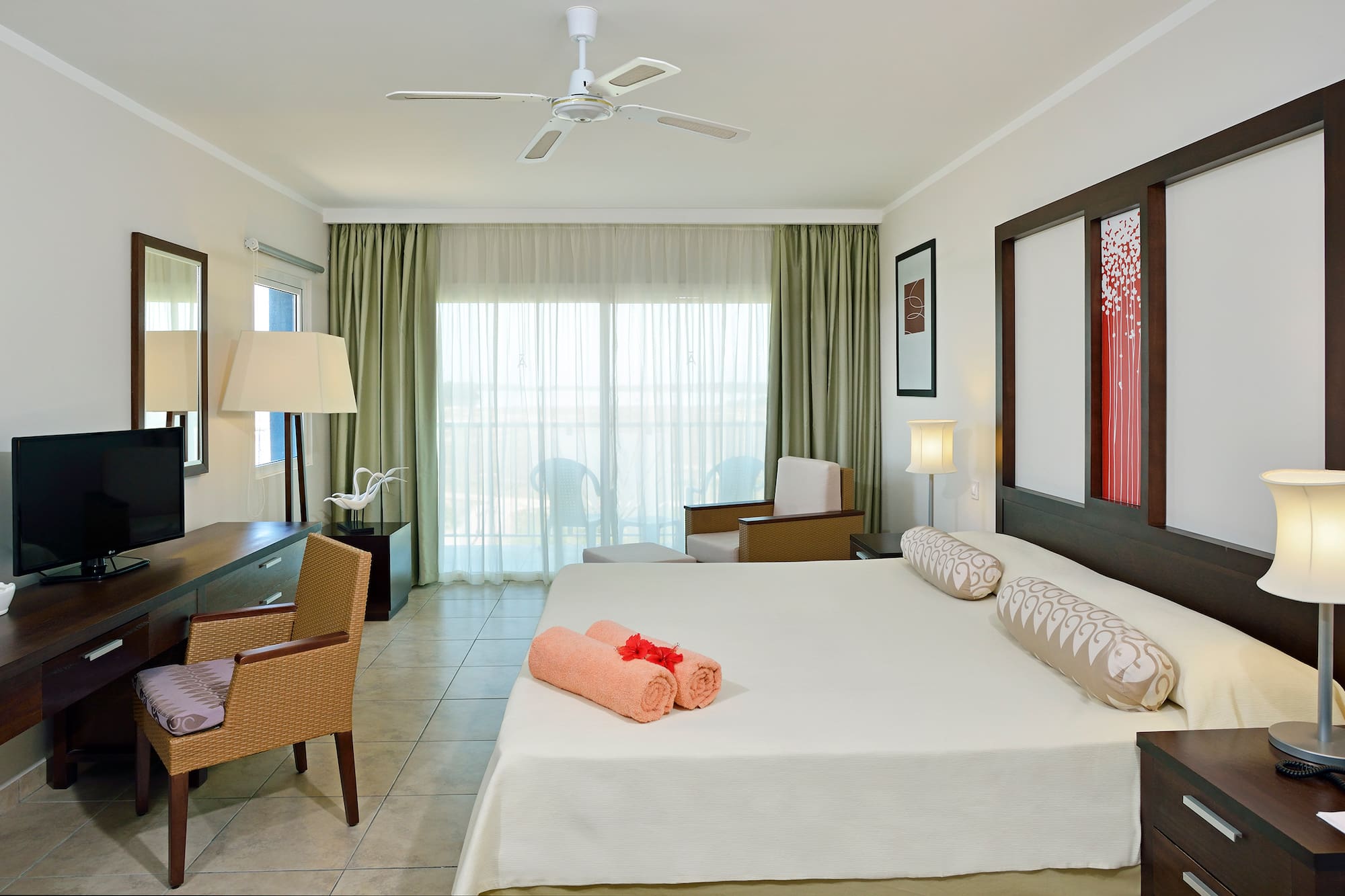 a room with a bed and a fan