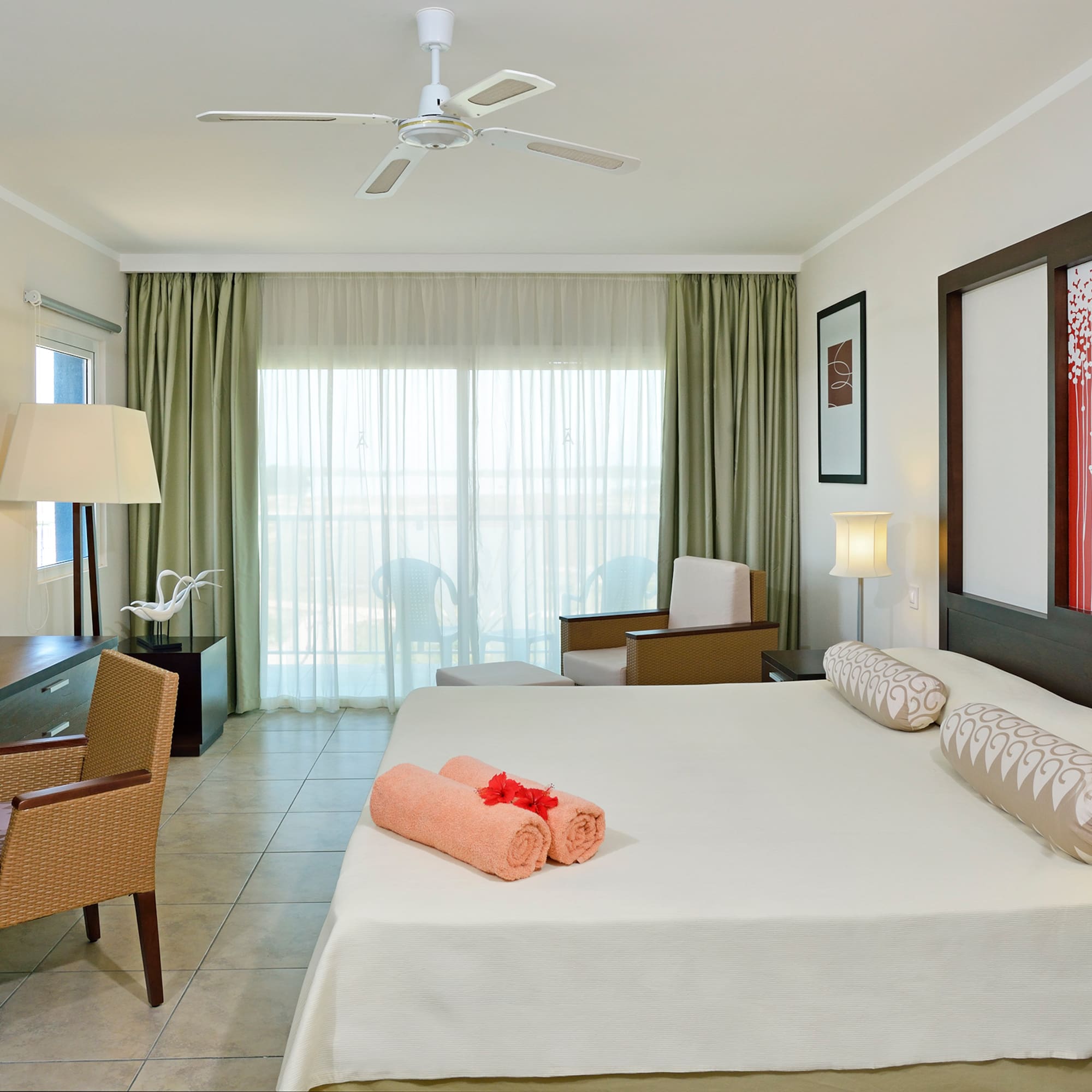 a room with a bed and a fan