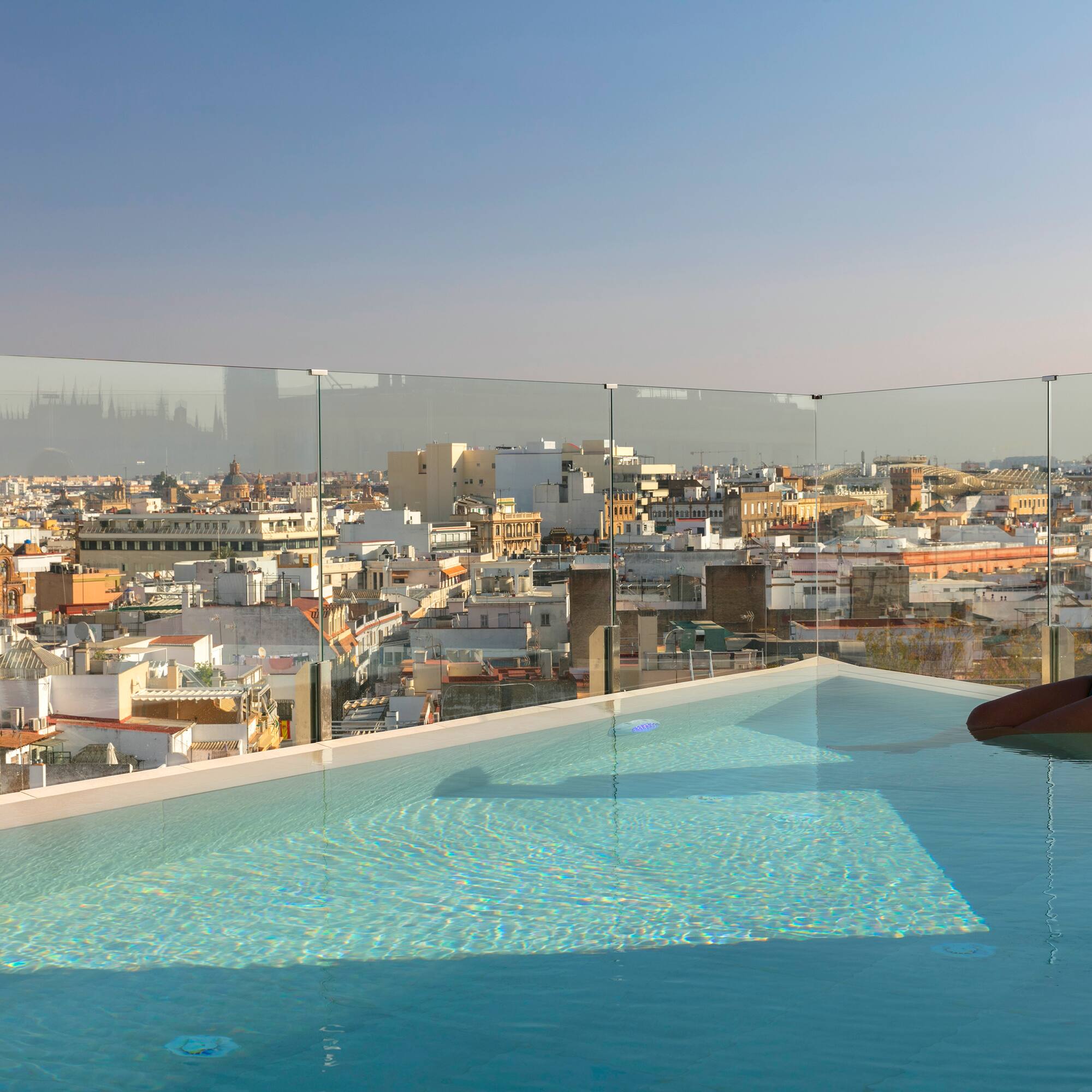 a person in a pool with a city in the background