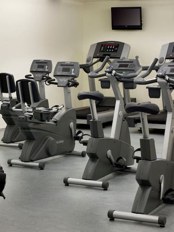 a room with exercise bikes and monitors