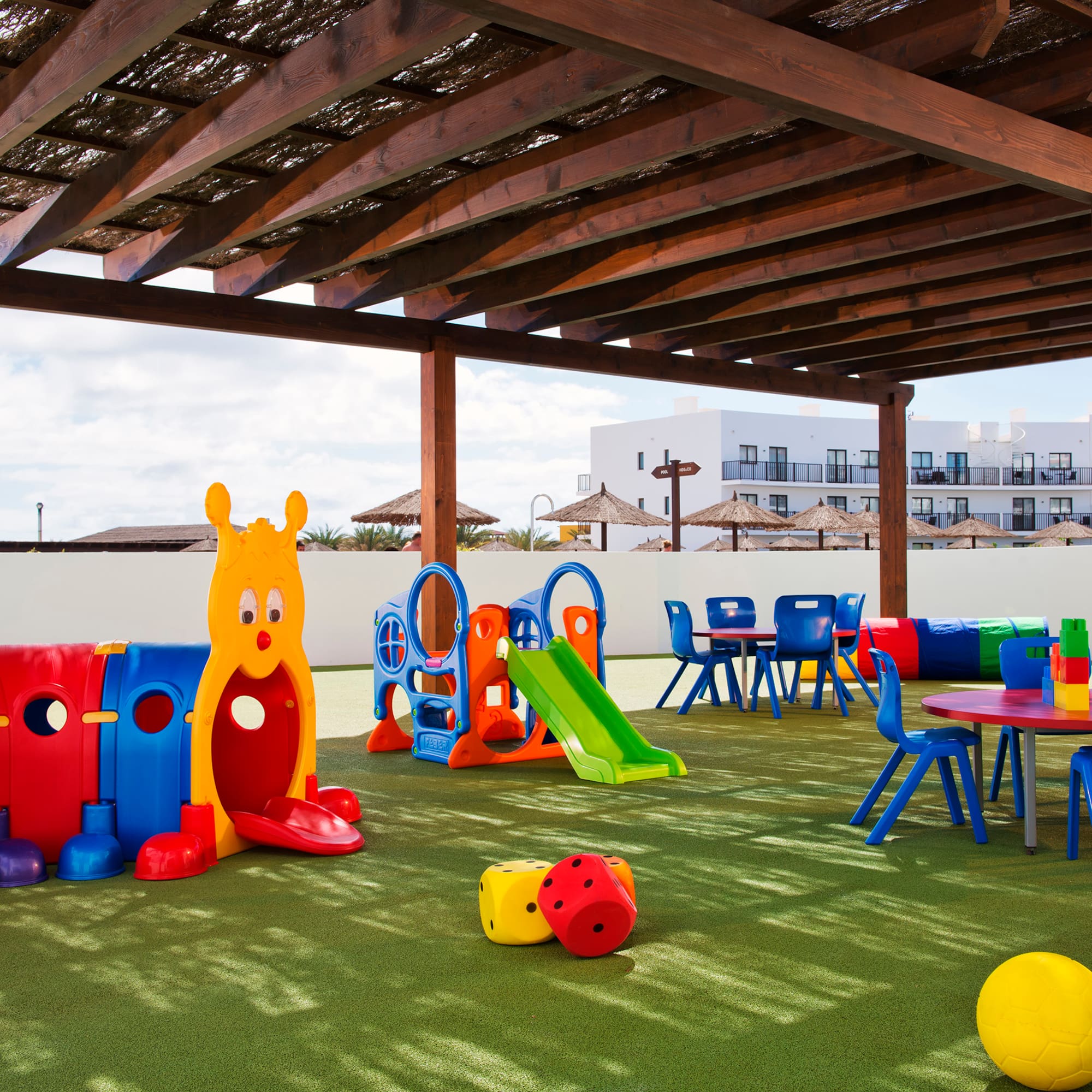 a playground with colorful toys and tables